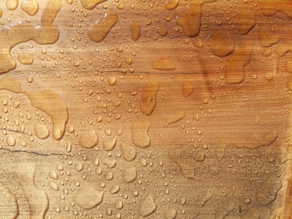 Treated wooden surface with water drops.